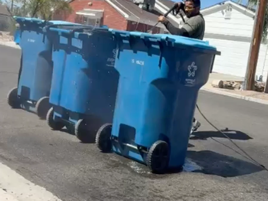 Row of residential bins being pressure washed on the street