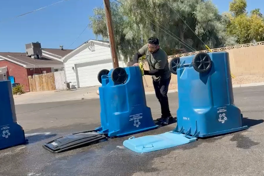 Trash bins tipped over to drain on the street after a full interior wash
